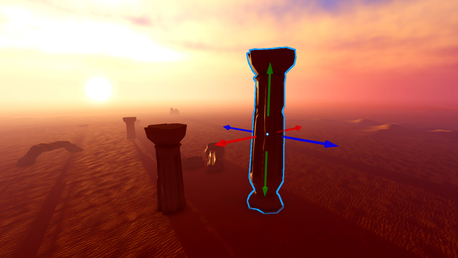 An example viewport display of a desert environment with multiple stone pillars. One of the pillars displays movement visual aids from the Move tool.